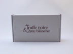 Box Truffe Noire & Patte Blanche fermée, carton blanc au logo marron